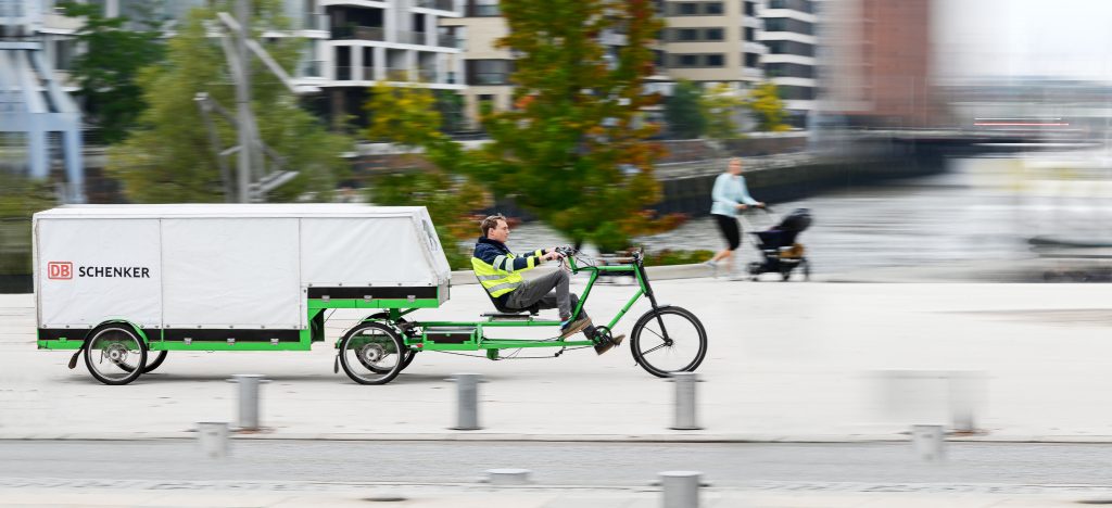 Person is driving a large Cargo Bike in the city of Hamburg